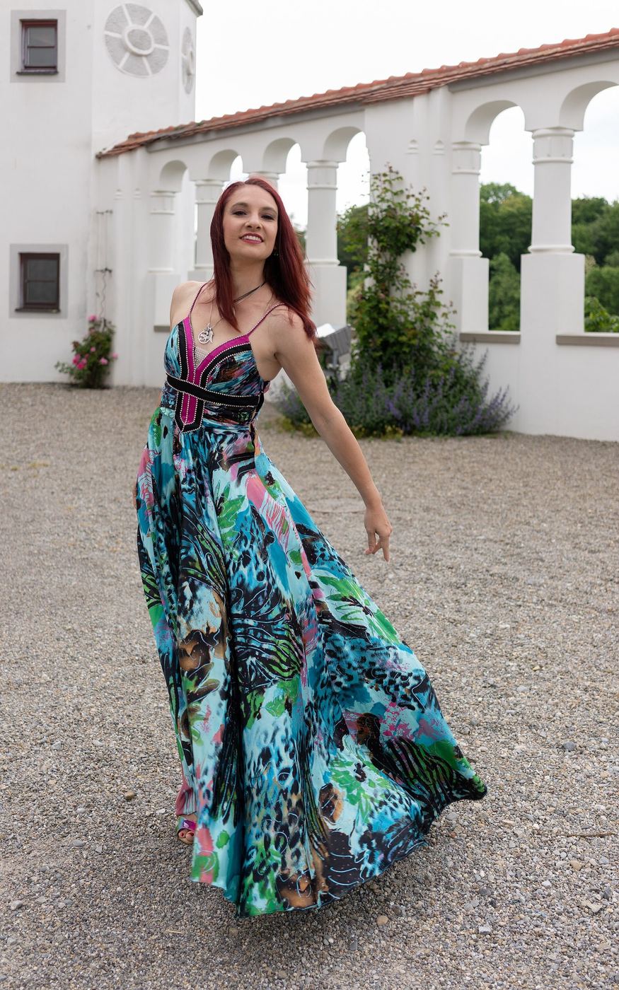 Dress with a circle skirt caught in the wind, photographed against an open field
